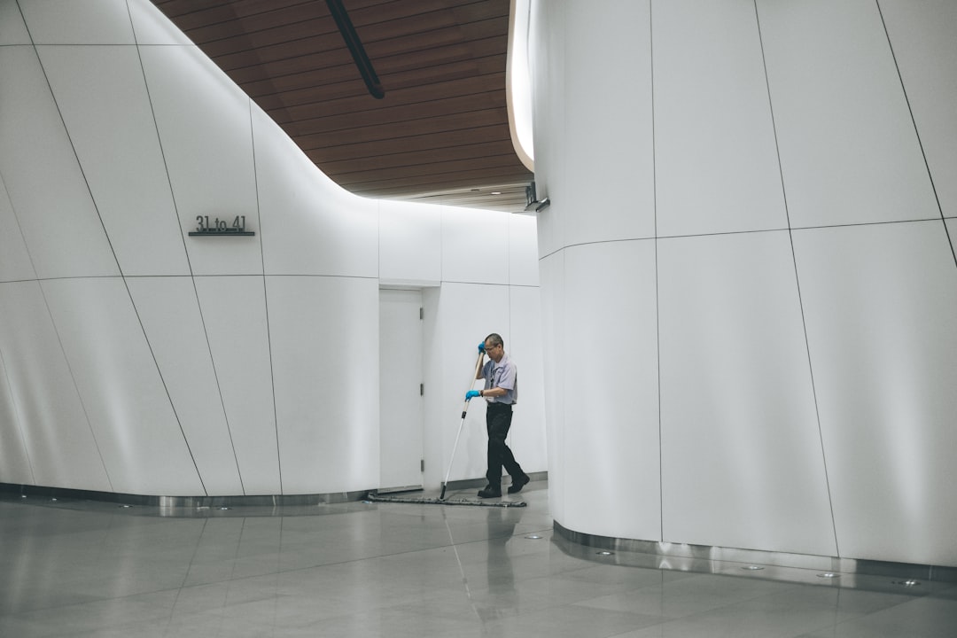 services-02 man-cleaning-on-floor-beside-white-wall-mww-zrkysiu